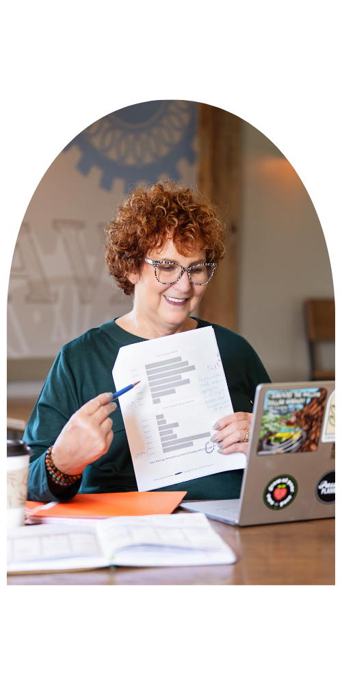 A photo of Allison Field on a video conference call holding a piece of paper