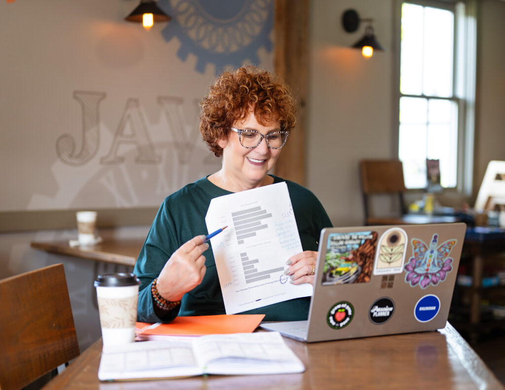 A photo of Allison Field on a video conference call holding a piece of paper